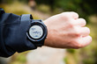 Hiker on mountain trail checking gps map