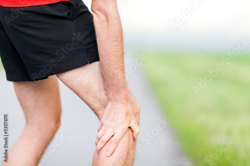 Photo: Runner leg and muscle pain during running training outdoors Runner leg and muscle pain during running training outdoors