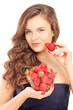 Photo: Beautiful young woman holding a bowl of strawberries Beautiful young woman holding a bowl of strawberries