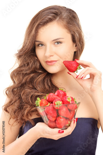Photo: Beautiful young woman holding a bowl of strawberries Beautiful young woman holding a bowl of strawberries