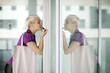 Photo: young business woman applying makeup in the street young business woman applying makeup in the street