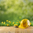 construction helmet on green nature background