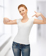 woman in blank white t-shirt pointing at herself