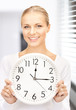 Photo: businesswoman with wall clock businesswoman with wall clock