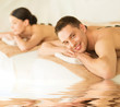 couple in spa with hot stones