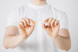 man breaking the cigarette with hands