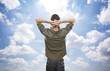 young man enjoying freedom on blue sky background