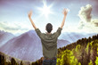 young man on top of the mountain, realxing and enjoying the view