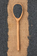 Wooden spoon with poppy seeds lying on sackcloth