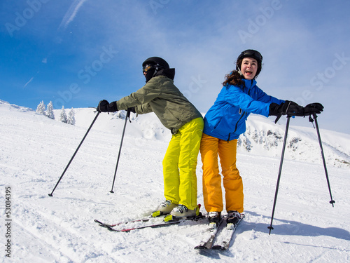 Photo: Teenage girl and boy skiing Teenage girl and boy skiing