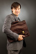 Young businessman holding his briefcase