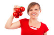 Happy young woman holding a branch of ripe tomatoes