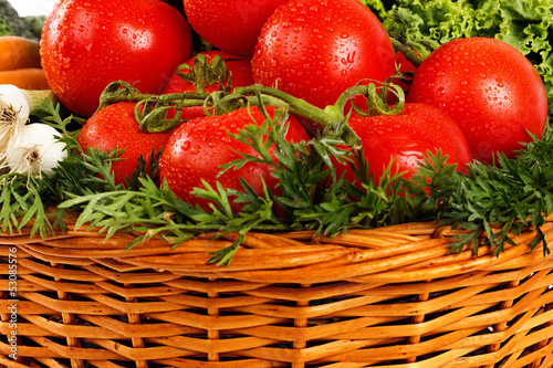 Photo: Closeup of fresh vegetables with water drops in basket Closeup of fresh vegetables with water drops in basket