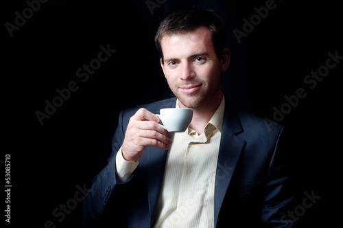 Photo: Low-key portrait of a business man drinking coffee Low-key portrait of a business man drinking coffee