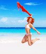 Photo: Woman jumping on the beach Woman jumping on the beach