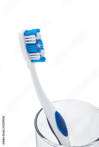 Photo: toothbrush with toothpaste in glass cup with clipping path toothbrush with toothpaste in glass cup with clipping path