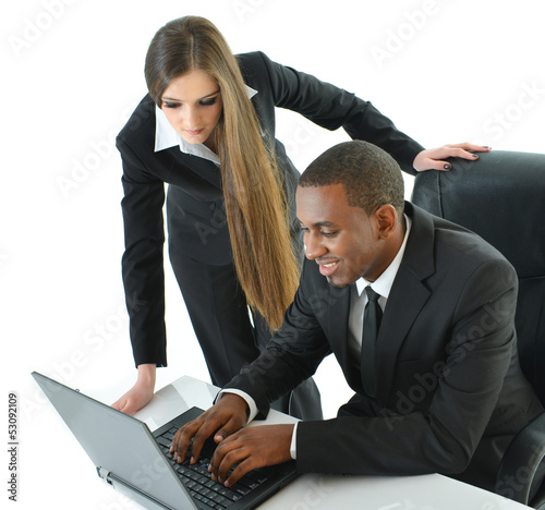 Photo: Two Co-Workers Working on Laptop Two Co-Workers Working on Laptop