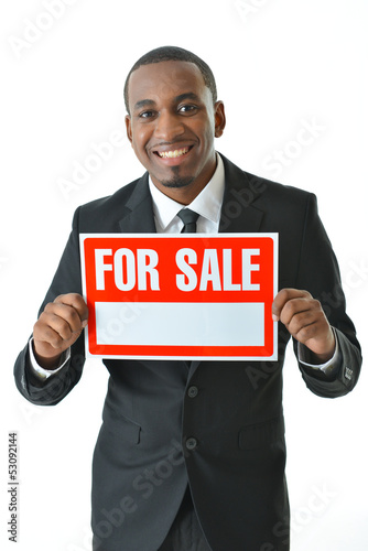 Photo: Salesman Holding "For Sale" Sign Salesman Holding "For Sale" Sign