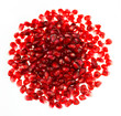 Red pomegranate  seeds in a round pile isolated on white