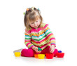 Photo: girl child playing with cup toys, isolated over white girl child playing with cup toys, isolated over white