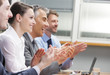 Clapping business people