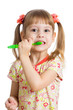 Photo: child girl brushing teeth isolated on white background child girl brushing teeth isolated on white background