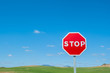 Stop sign over blue sky background