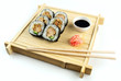 Teriyaki chicken sushi on bamboo tray with soy sauce and ginger