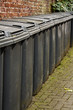 Photo: Row of residential wheelie bins Row of residential wheelie bins
