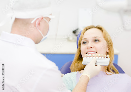 Photo: smiling woman with palette for tooth color smiling woman with palette for tooth color
