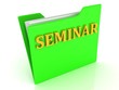 SEMINAR bright yellow letters on a green folder with papers