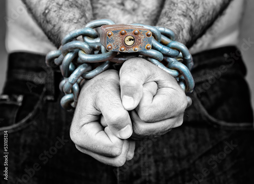 Photo: Man with his two hands chained Man with his two hands chained