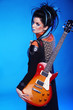 Back of Rock emo girl posing with electric guitar isolated on bl