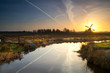 Photo: sunbeam behind windmill at sunrise sunbeam behind windmill at sunrise