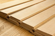 Wood planks are on a wooden board with sawdust