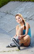 Beautiful young woman rink on roller-skate