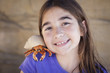 Young Girl Playing with Toy Hermit Crab