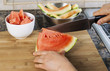 Photo: Large Kitchen knife cutting watermelon on bamboo board Large Kitchen knife cutting watermelon on bamboo board
