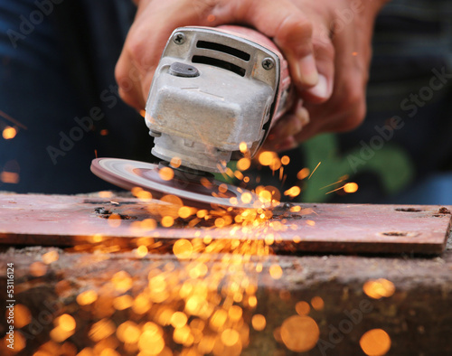 Photo: Metal grinding on steel pipe close up Metal grinding on steel pipe close up