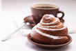 Cup of Black Tea on White Napkin with Sweet Bun