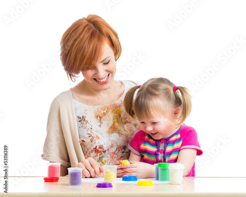 Photo: mother and daughter play with dough mother and daughter play with dough