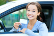 girl in a car showing a key and an empty white card