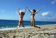 Photo: Young women high jump on a beach Young women high jump on a beach