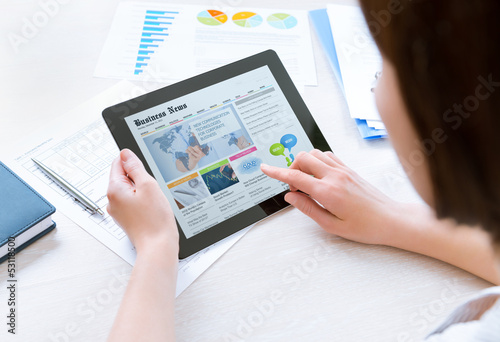 Photo: Businesswoman reading latest news Businesswoman reading latest news