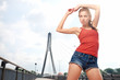Beautiful woman after fitness training on bridge