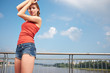Beautiful woman after fitness training on bridge