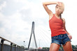 Photo: Beautiful woman after fitness training on bridge Beautiful woman after fitness training on bridge