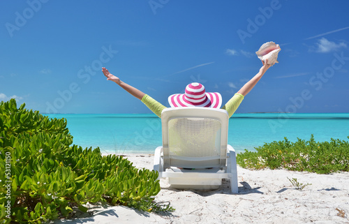 Photo: Girl with a shell on the sunbed looking to the ocean. Exuma, Bah Girl with a shell on the sunbed looking to the ocean. Exuma, Bah
