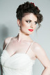 Studio portrait of Hispanic bride in white dress