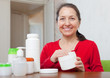 Happy woman uses cosmetic cream
